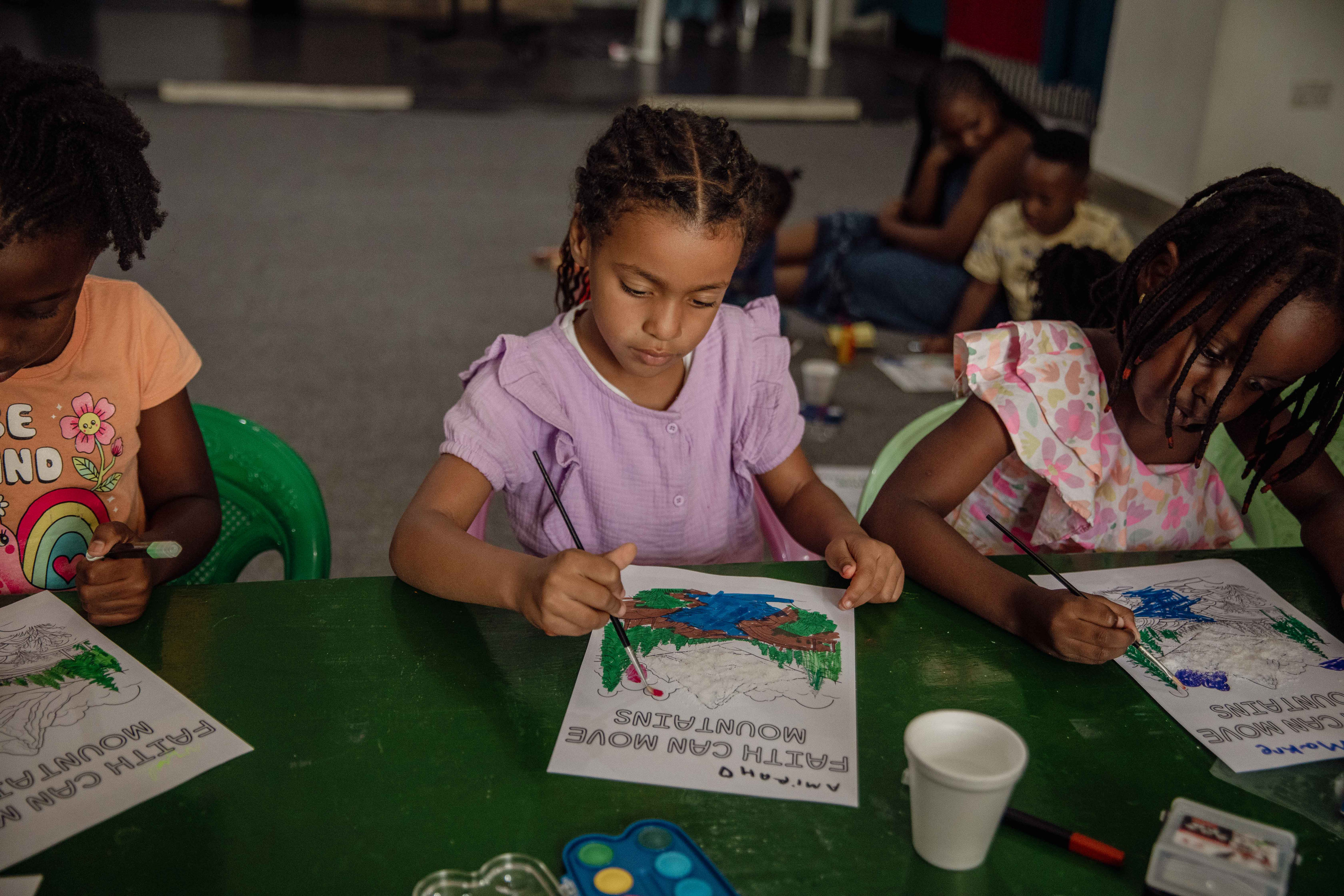 Children colour together at summer camp