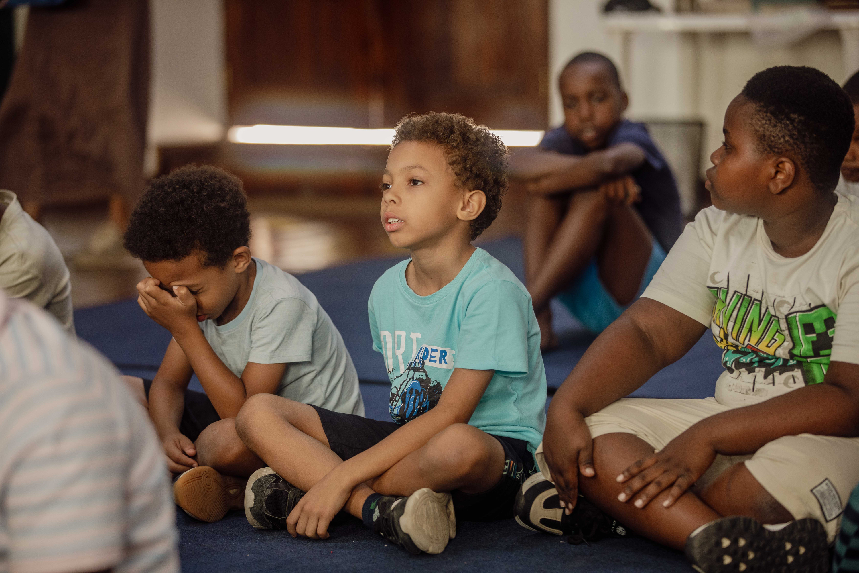 A kids leader teaches a room of children at Ocean Kids