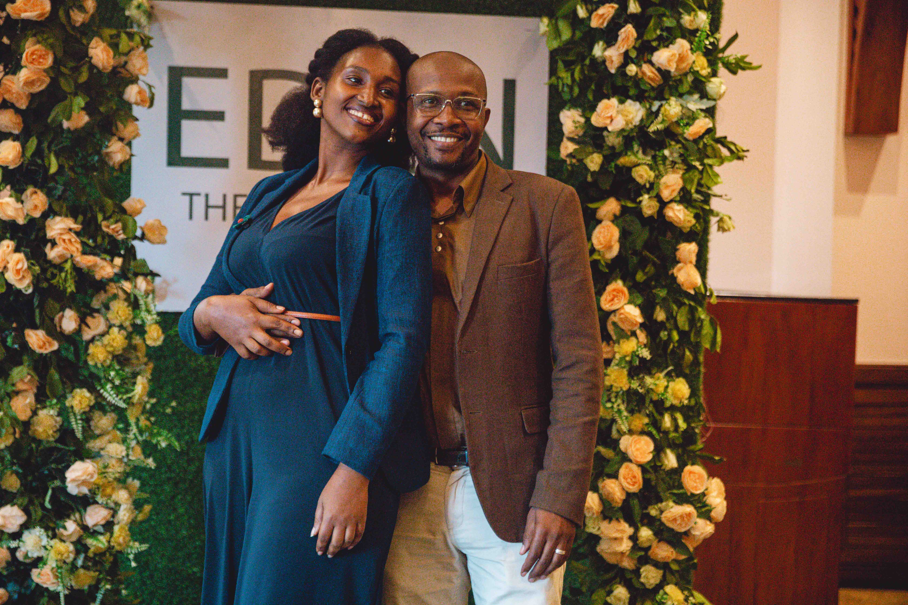 A couple in front of the EDEN backdrop