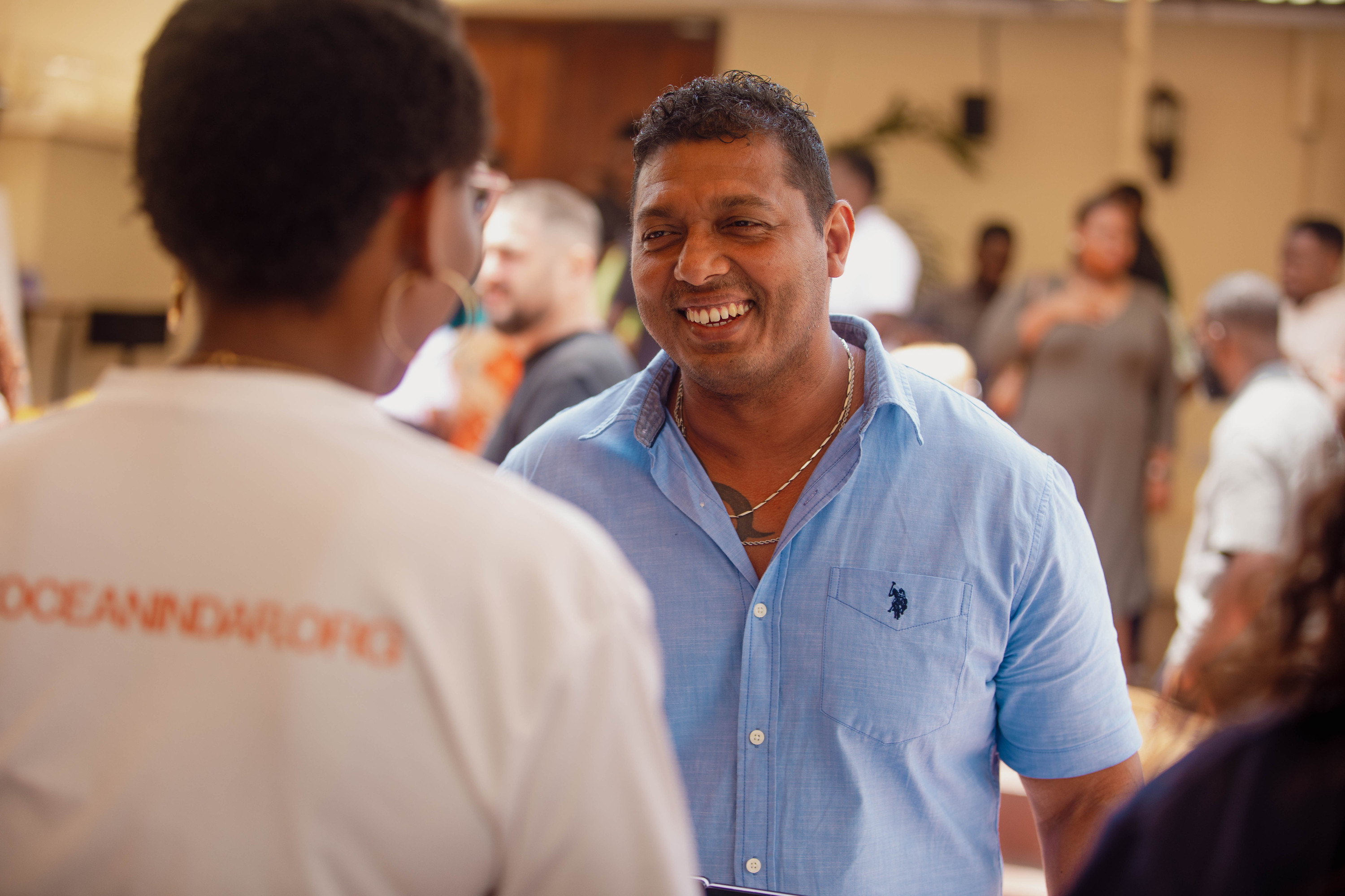 A man smiles at a greeter at the door on a Sunday