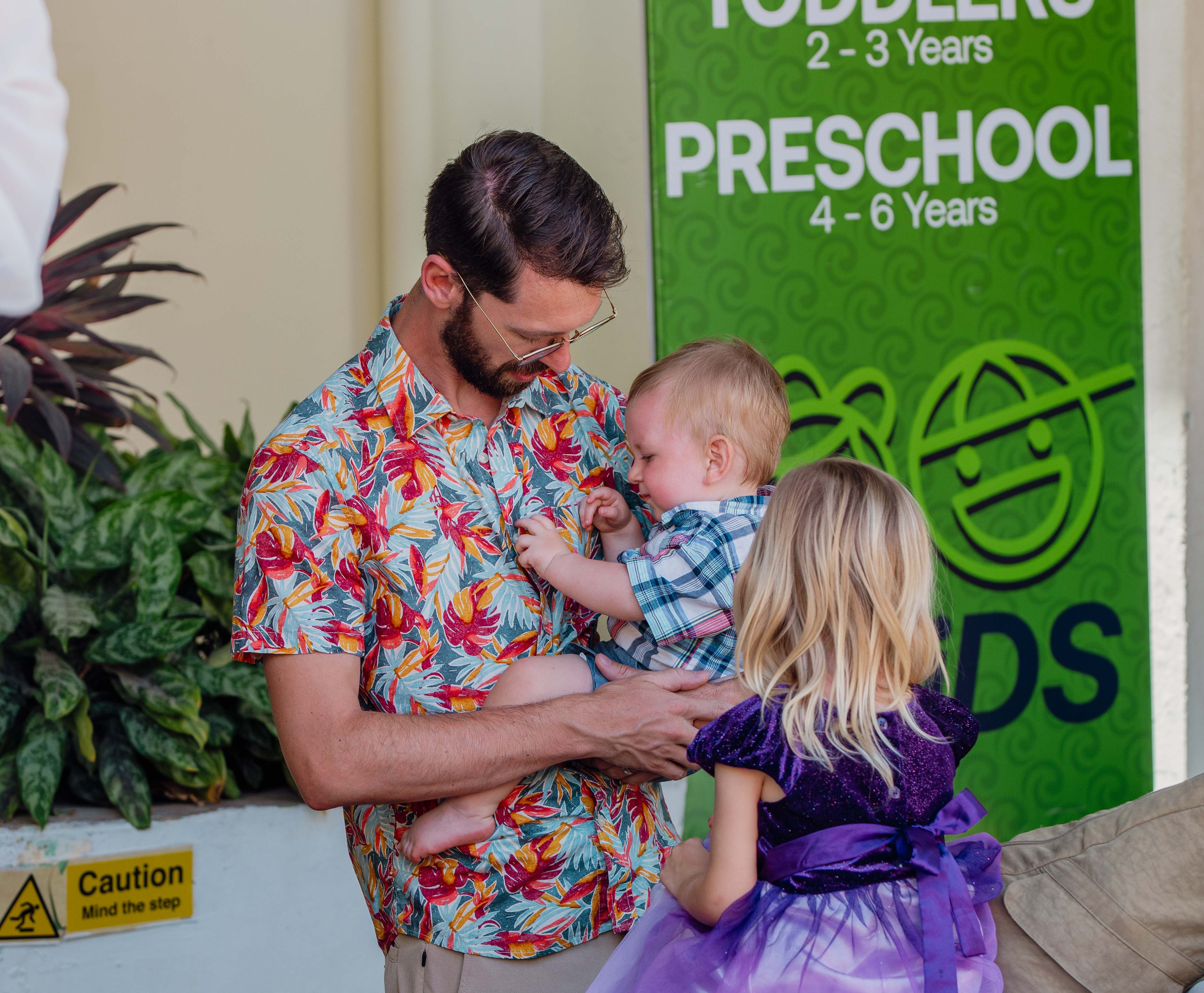 A volunteer checks a child in at Ocean Kids