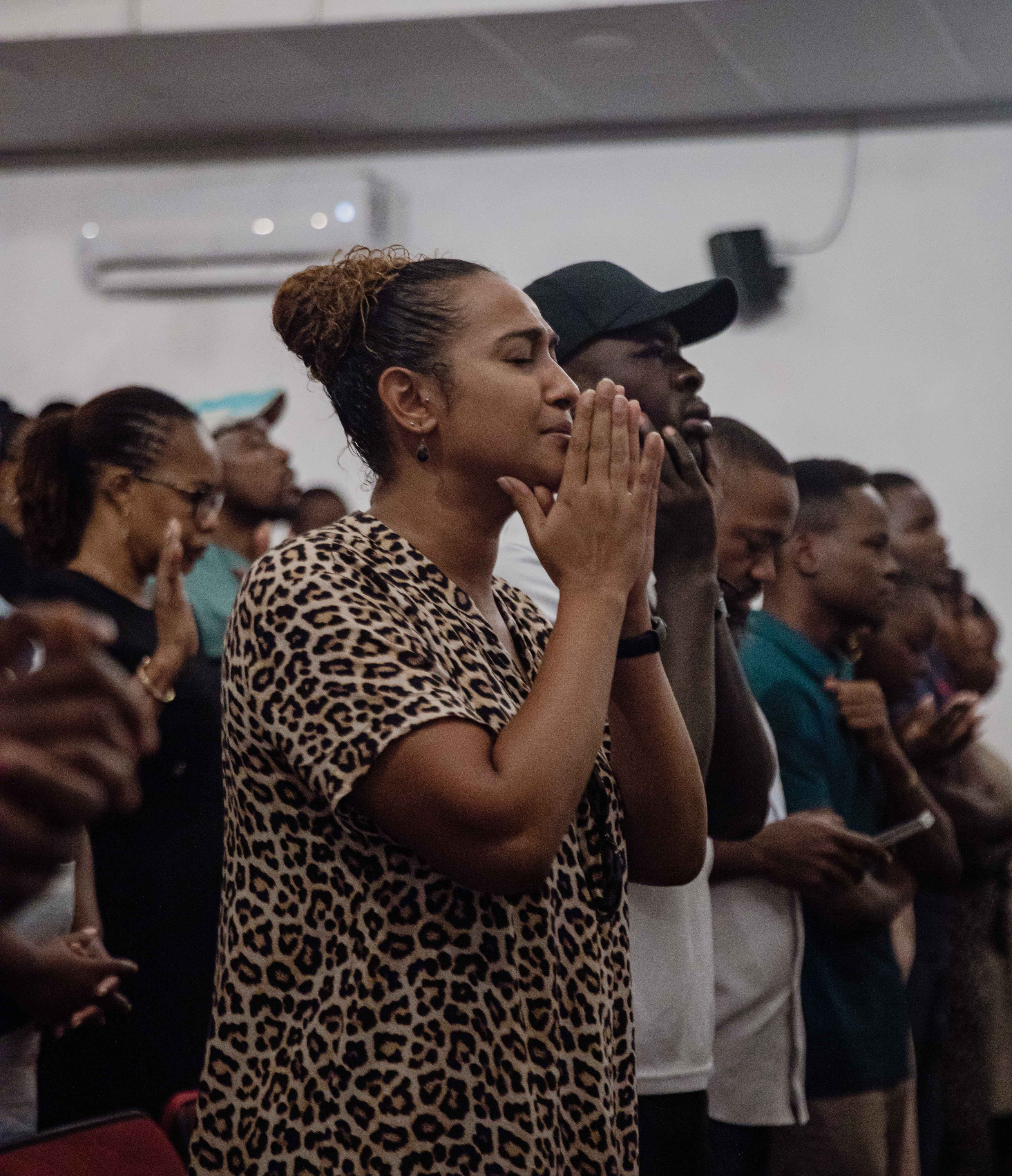 A woman prays with her hands pressed together