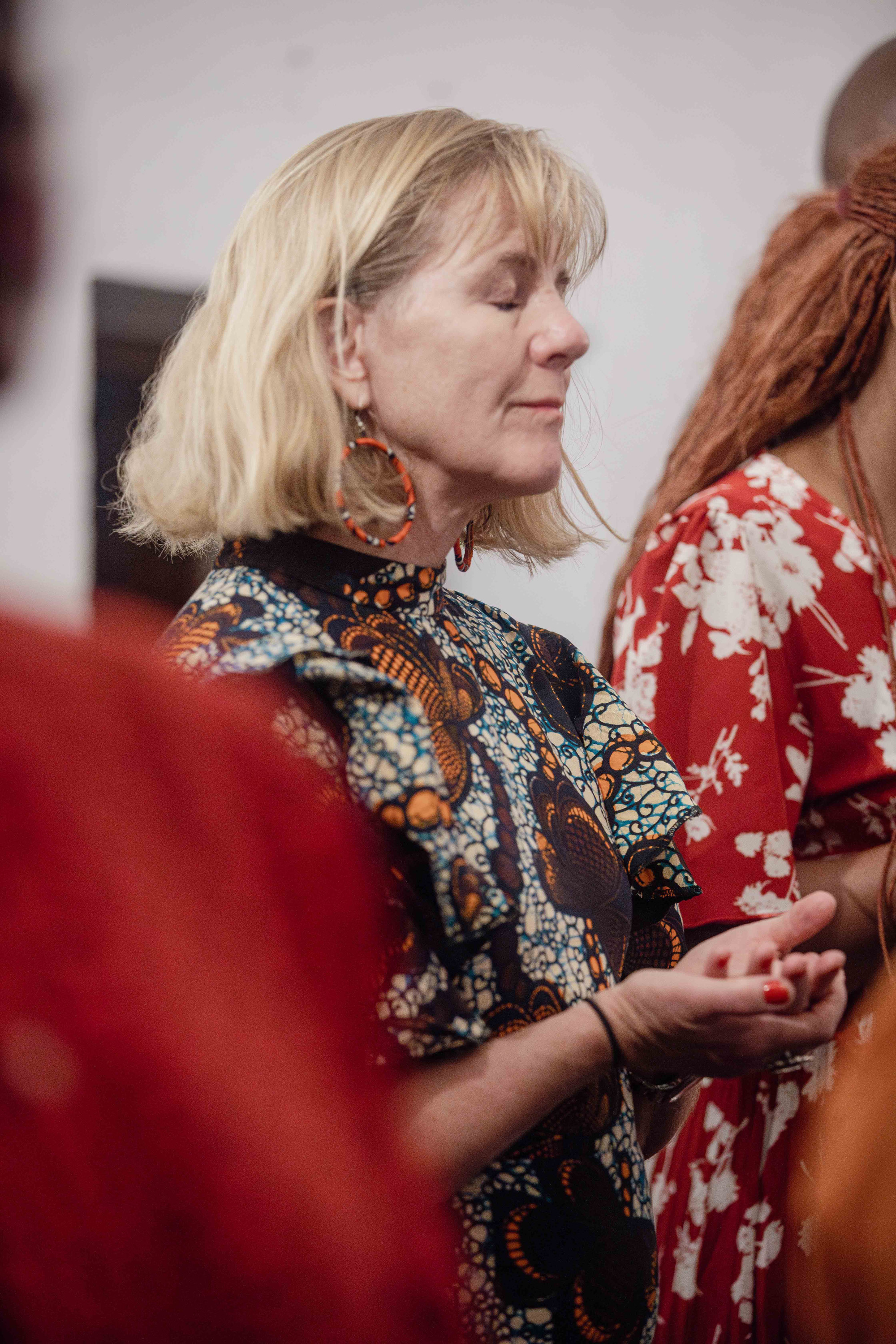 A woman prays with her hands pressed together