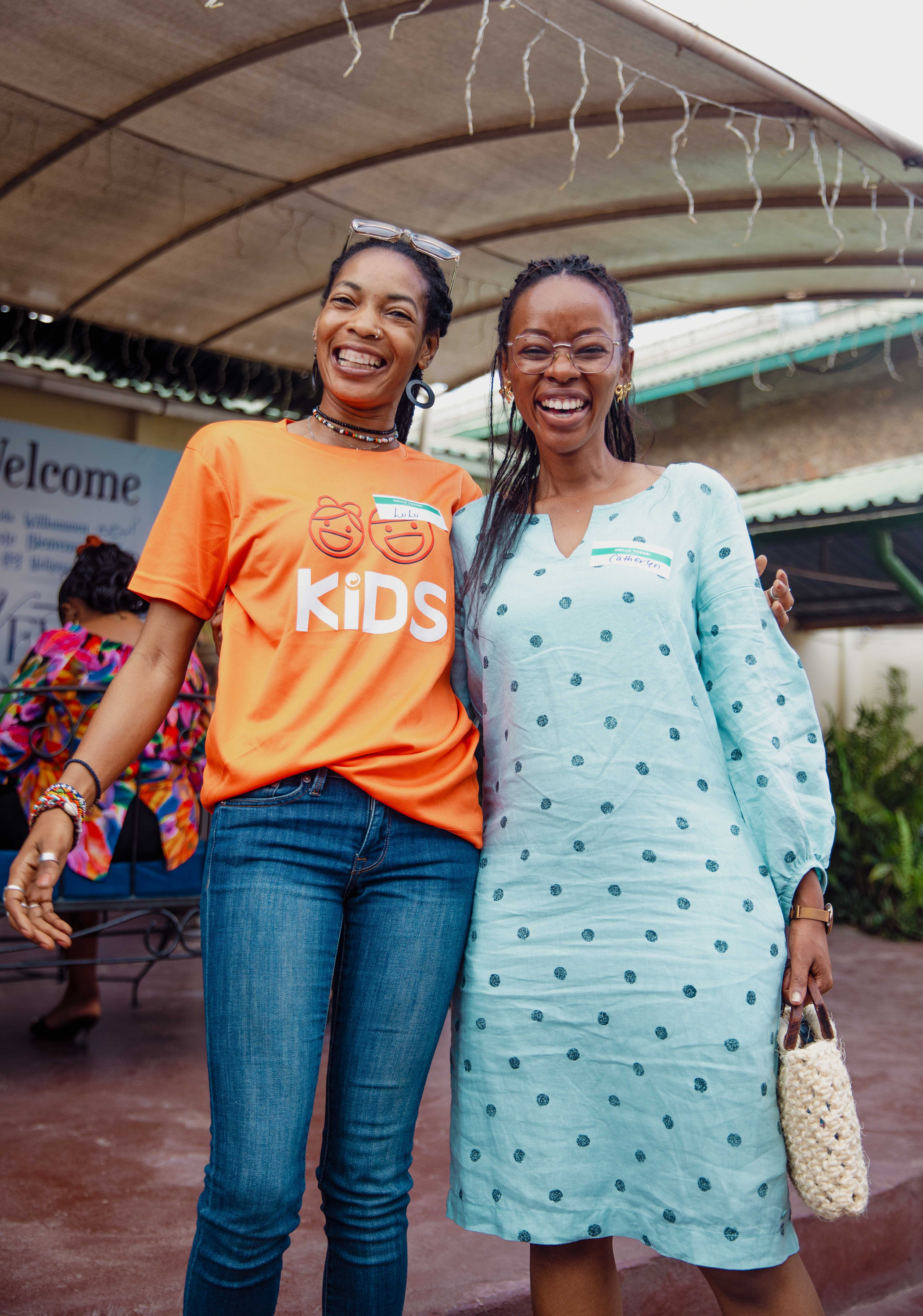 Two women from the kids team laugh together